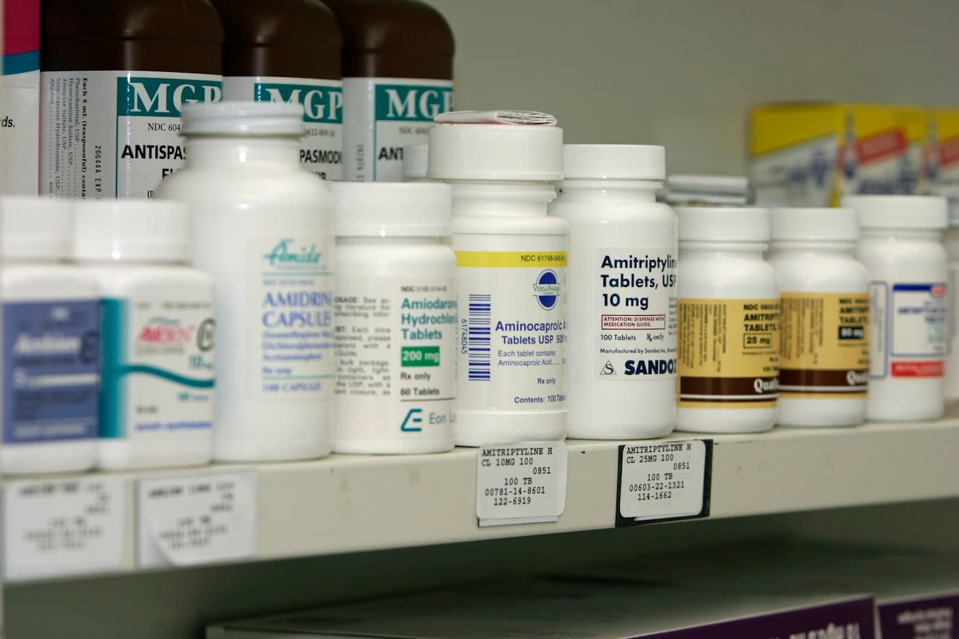 Rayon de pharmacie garni de flacons de médicaments étiquetés